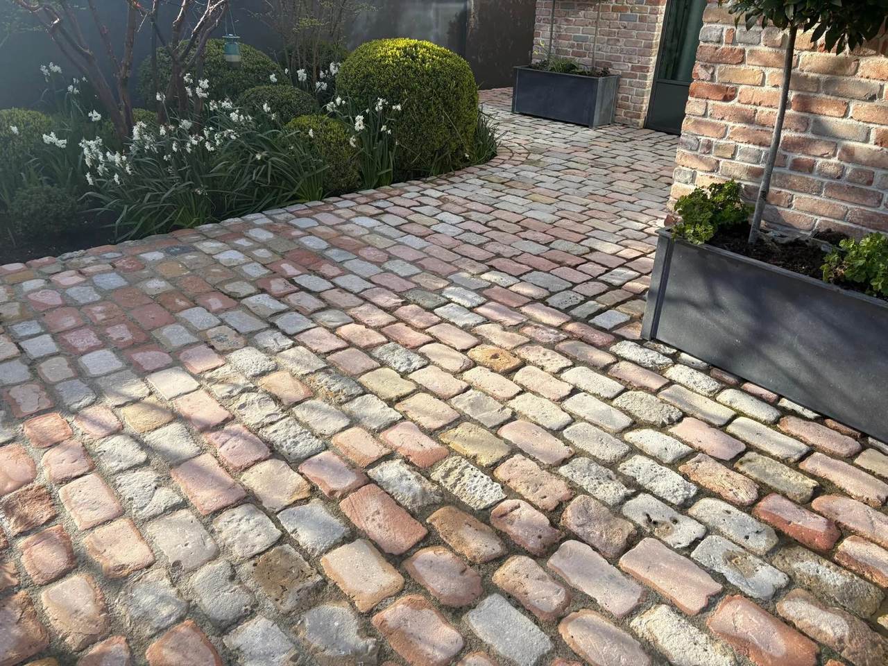 Curved cobble path cleaned by Costello Cleaning Services